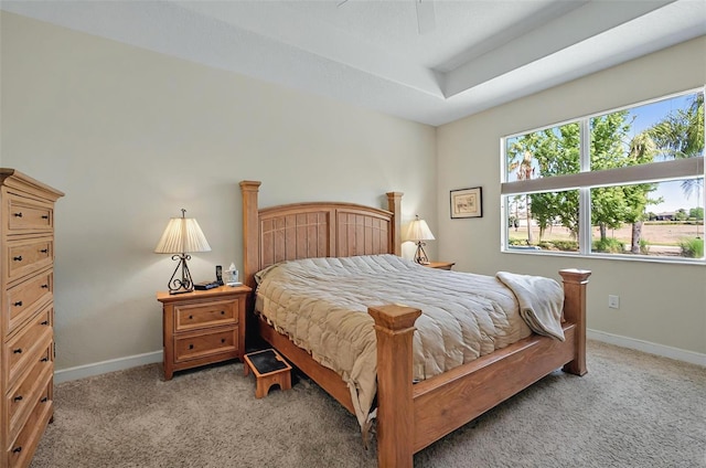 bedroom featuring light colored carpet and baseboards