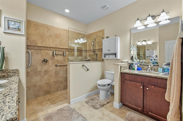 bathroom with vanity, visible vents, and a walk in shower