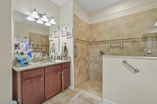 full bathroom with tile patterned floors, vanity, and a walk in shower