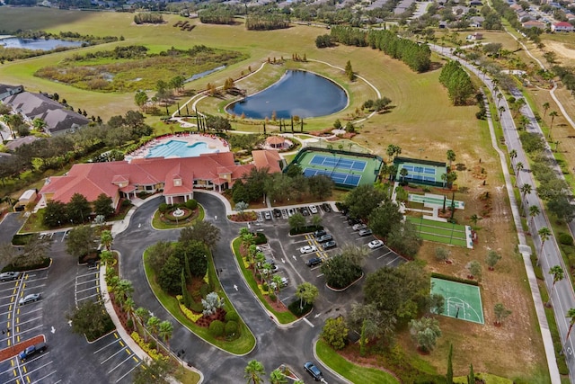 drone / aerial view with a water view and golf course view