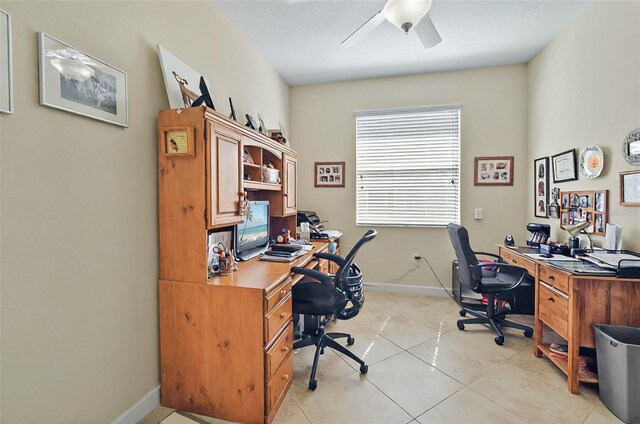 home office with light tile patterned flooring, baseboards, and a ceiling fan