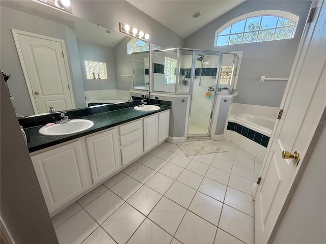 full bathroom with vaulted ceiling, a bath, tile patterned floors, a shower stall, and double vanity