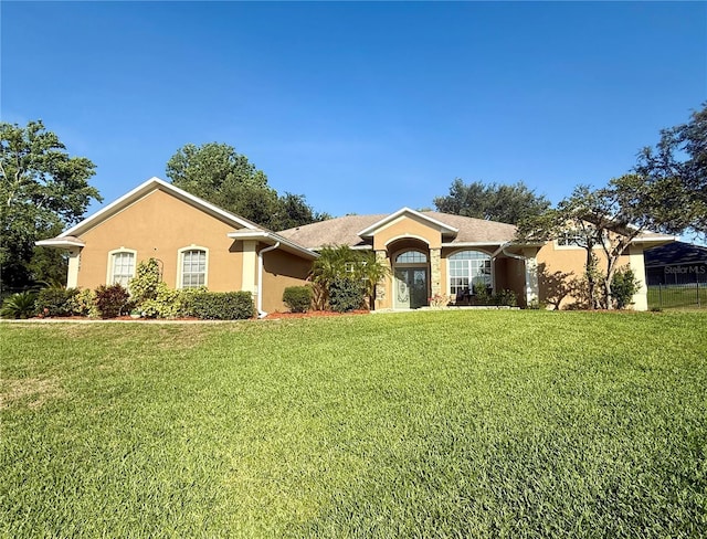 single story home featuring stucco siding and a front lawn