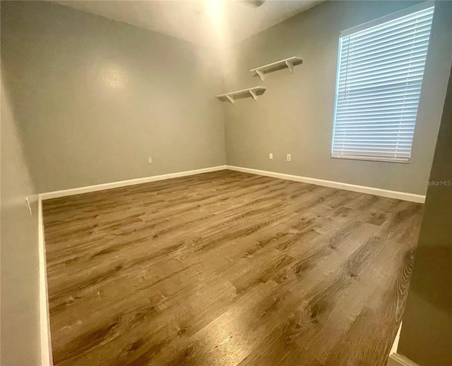 spare room with wood finished floors and baseboards
