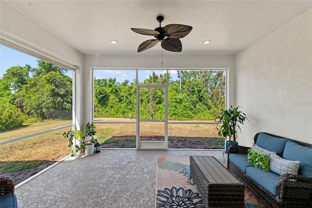 sunroom / solarium featuring an outdoor living space and a ceiling fan