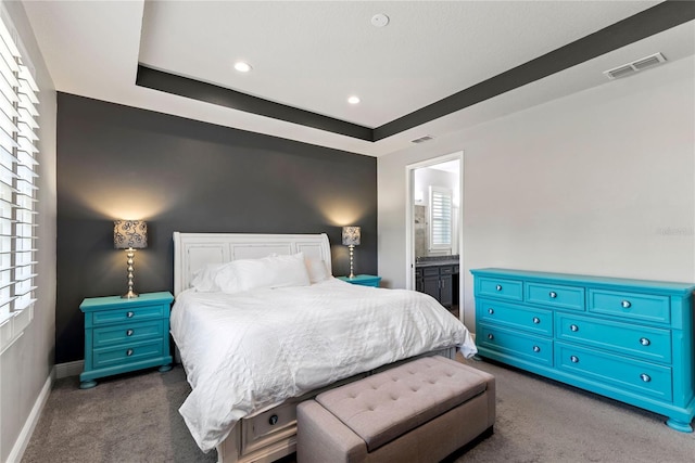 bedroom featuring visible vents, baseboards, multiple windows, and dark colored carpet