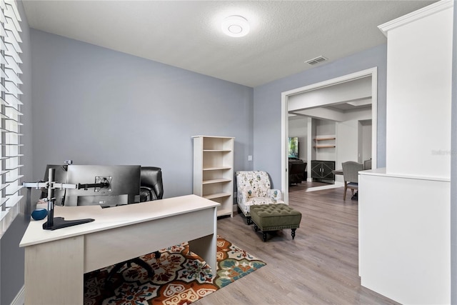 office space with visible vents and light wood-type flooring