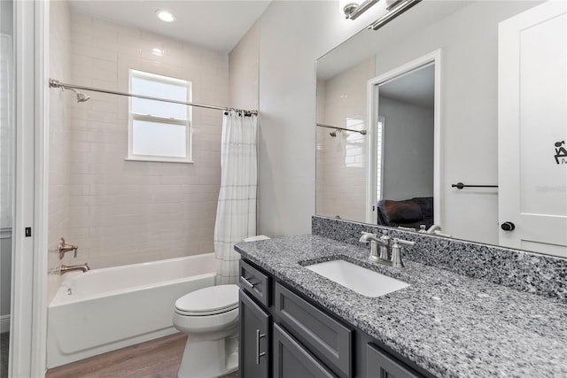 full bathroom featuring wood finished floors, vanity, toilet, shower / tub combo with curtain, and recessed lighting