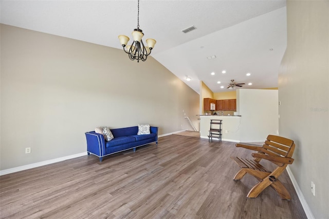 5492 Compass Pt, Oxford, FL 34484 - sitting room featuring an inviting chandelier, baseboards, vaulted ceiling, and wood finished floors