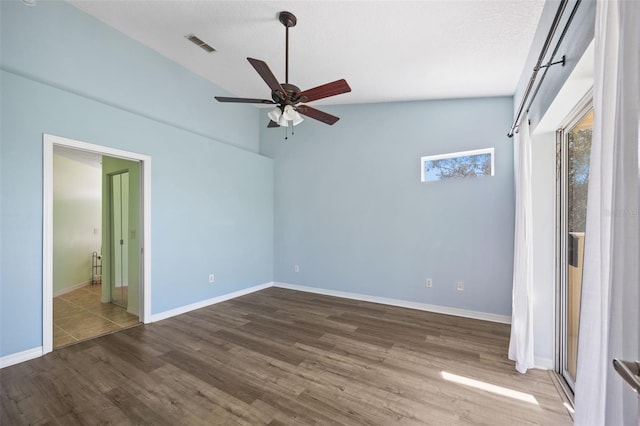 5492 Compass Pt, Oxford, FL 34484 - unfurnished bedroom featuring visible vents, wood finished floors, baseboards, a ceiling fan, and vaulted ceiling