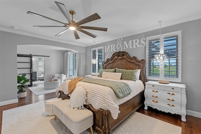 bedroom featuring dark wood-style flooring, arched walkways, a barn door, baseboards, and ornamental molding