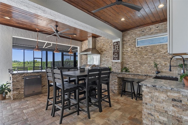 exterior space featuring a ceiling fan, a sink, outdoor wet bar, and area for grilling