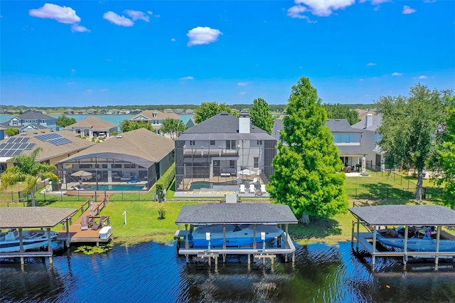 view of dock with a residential view, fence, boat lift, and a water view