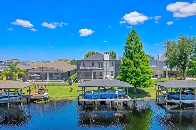 dock area featuring boat lift, a residential view, and a water view