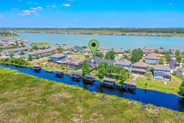 drone / aerial view with a water view and a residential view