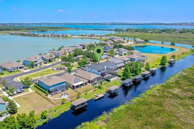 birds eye view of property with a water view and a residential view