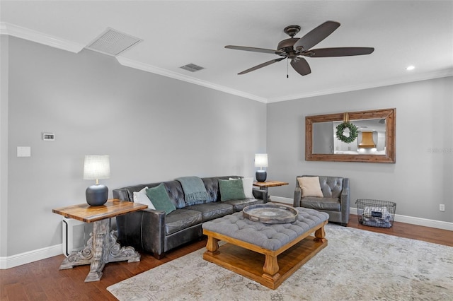 living room featuring visible vents, baseboards, and crown molding