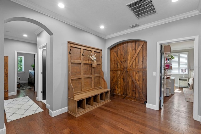 mudroom with visible vents, wood finished floors, and a healthy amount of sunlight