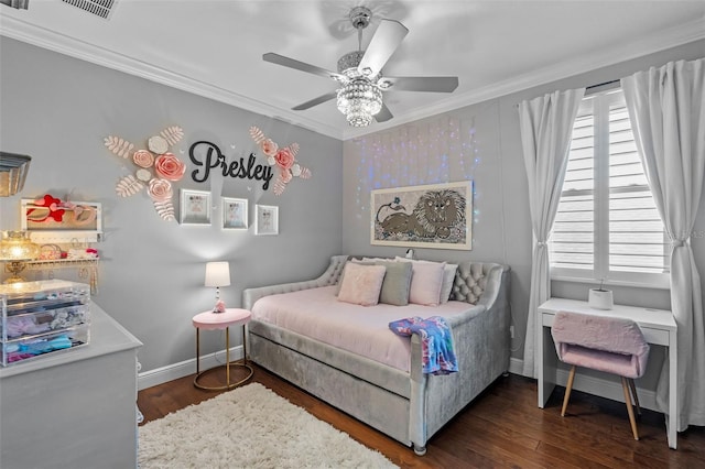 bedroom featuring crown molding, baseboards, and wood finished floors