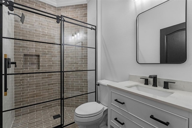 bathroom featuring vanity, ornamental molding, a stall shower, and toilet