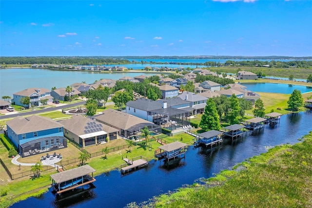 drone / aerial view with a water view and a residential view