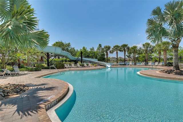 722 Barefoot Bay Loop, Groveland, FL 34736 - community pool with a water slide and a patio