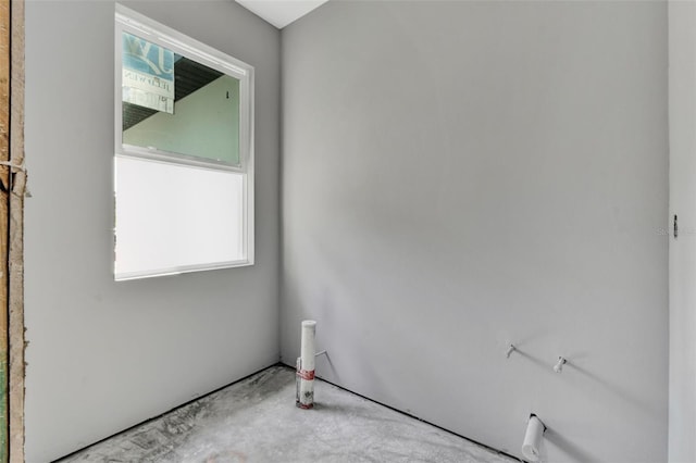 unfurnished room featuring concrete floors