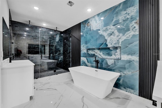 bathroom featuring recessed lighting, tile walls, a marble finish shower, and stone wall