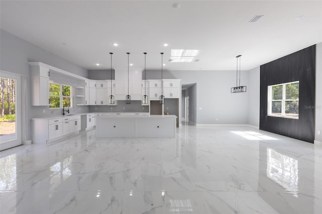 42191 Cashew St, Eustis, FL 32736 - kitchen with open shelves, white cabinets, light marble finish floors, decorative light fixtures, and recessed lighting