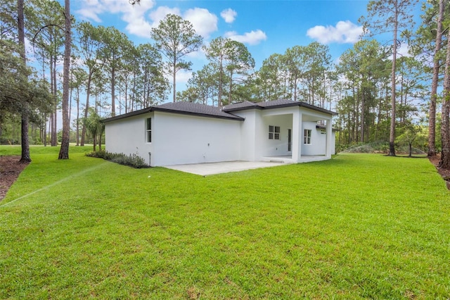42191 Cashew St, Eustis, FL 32736 - rear view of property with stucco siding, a patio, and a lawn