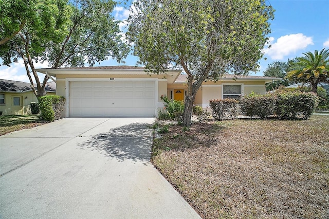 705 Grand Vista Trl, Leesburg, FL 34748 - single story home with stucco siding, an attached garage, and driveway