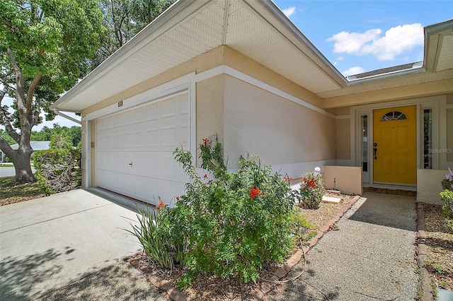 705 Grand Vista Trl, Leesburg, FL 34748 - exterior space with an attached garage, driveway, and stucco siding