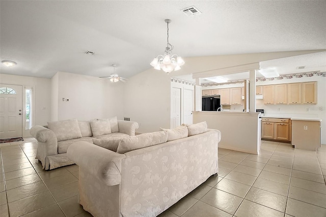 705 Grand Vista Trl, Leesburg, FL 34748 - living area featuring light tile patterned flooring, vaulted ceiling, visible vents, and ceiling fan with notable chandelier