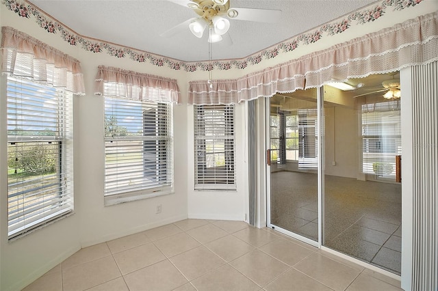 705 Grand Vista Trl, Leesburg, FL 34748 - empty room featuring baseboards, a ceiling fan, tile patterned floors, and a wealth of natural light