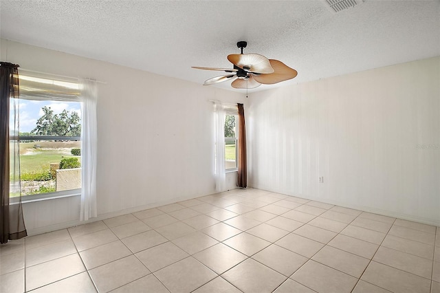 705 Grand Vista Trl, Leesburg, FL 34748 - spare room featuring ceiling fan, light tile patterned flooring, a textured ceiling, and visible vents