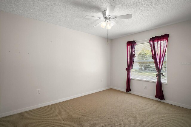 705 Grand Vista Trl, Leesburg, FL 34748 - spare room with a ceiling fan, a textured ceiling, light carpet, and baseboards