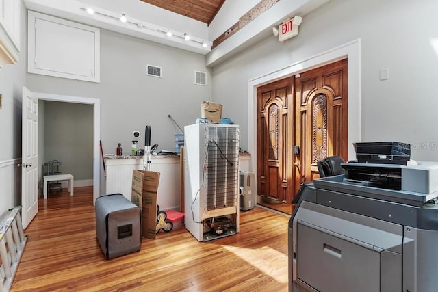 interior space with visible vents, rail lighting, and light wood-style floors