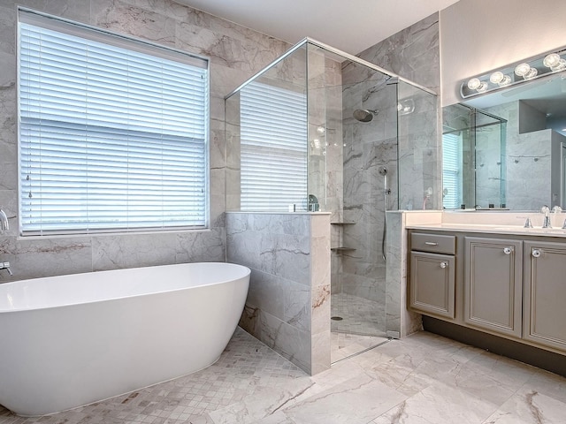3775 Brantley Place Cir, Apopka, FL 32703 - bathroom with a freestanding tub, vanity, marble finish floors, and a stall shower