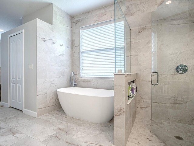 3775 Brantley Place Cir, Apopka, FL 32703 - full bathroom featuring a shower stall, a freestanding tub, and marble finish floors