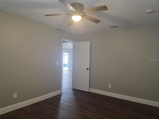 unfurnished room featuring dark wood-style floors, ceiling fan, baseboards, a smoke detector, and a textured ceiling