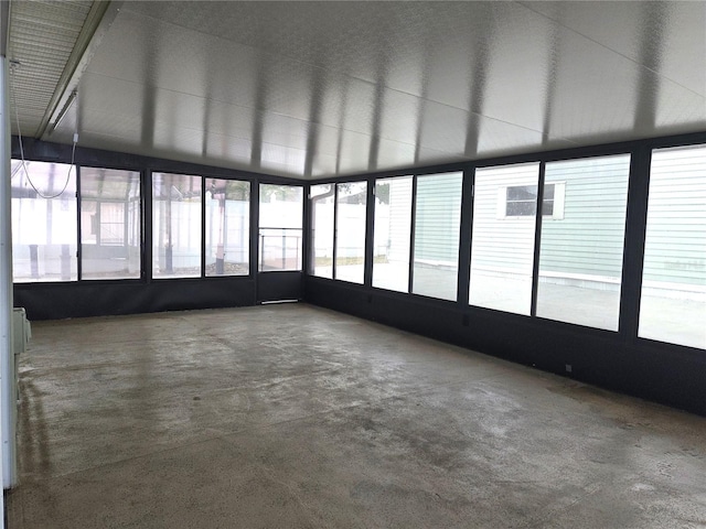unfurnished sunroom with concrete floors