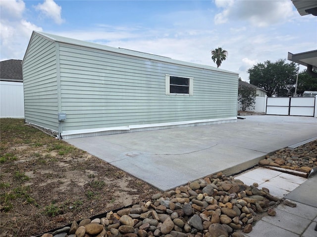 back of property featuring a patio area and fence