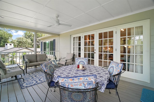 wooden deck featuring an outdoor living space, a ceiling fan, french doors, and outdoor dining area