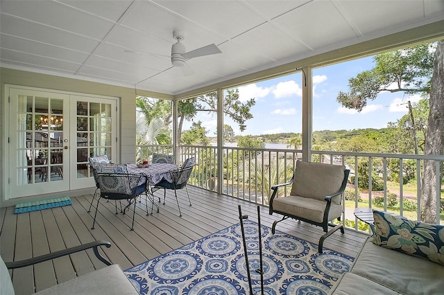 sunroom featuring ceiling fan, french doors, and outdoor dining space