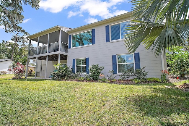 back of house featuring a sunroom and a yard