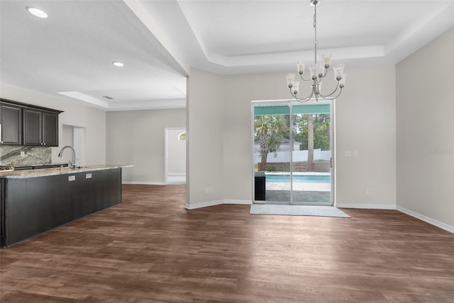 11344 Gallinule Ave, Weeki Wachee, FL 34613 - unfurnished dining area featuring recessed lighting, a raised ceiling, baseboards, and dark wood-style flooring