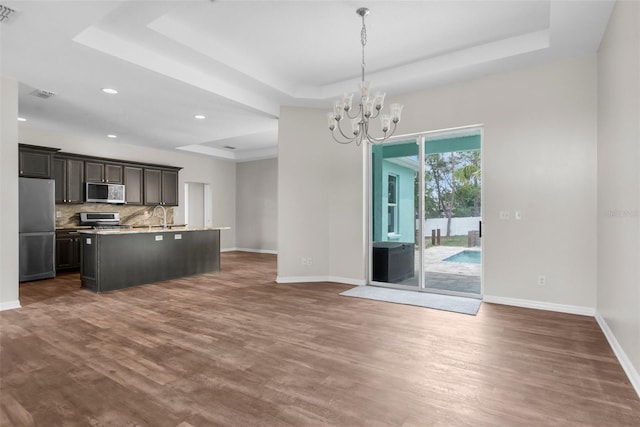 11344 Gallinule Ave, Weeki Wachee, FL 34613 - kitchen with baseboards, appliances with stainless steel finishes, and a tray ceiling