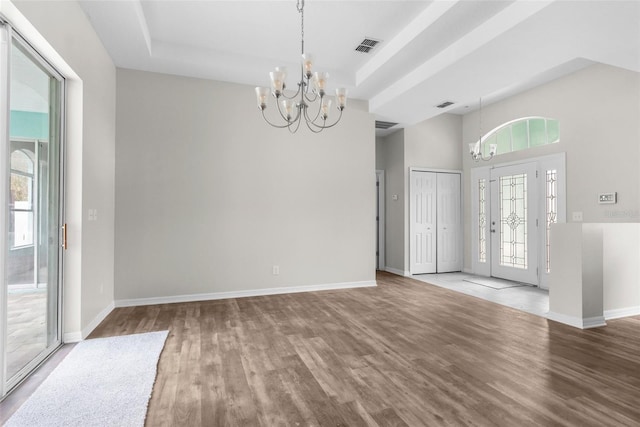 11344 Gallinule Ave, Weeki Wachee, FL 34613 - unfurnished dining area featuring baseboards, an inviting chandelier, wood finished floors, and visible vents