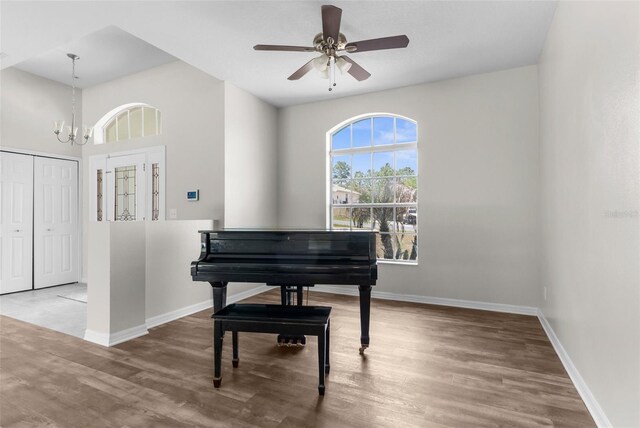11344 Gallinule Ave, Weeki Wachee, FL 34613 - sitting room with baseboards, wood finished floors, and ceiling fan with notable chandelier