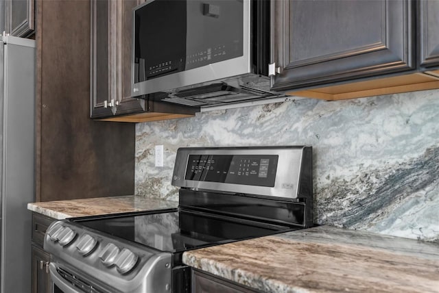 11344 Gallinule Ave, Weeki Wachee, FL 34613 - details with appliances with stainless steel finishes, backsplash, and dark brown cabinets